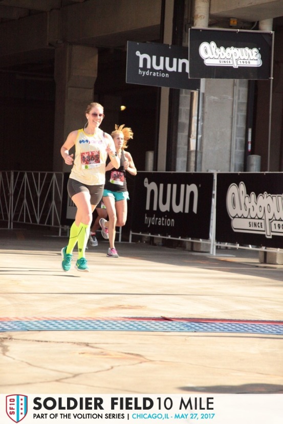 Photo of author running across the finish line of a race at Soldier Field